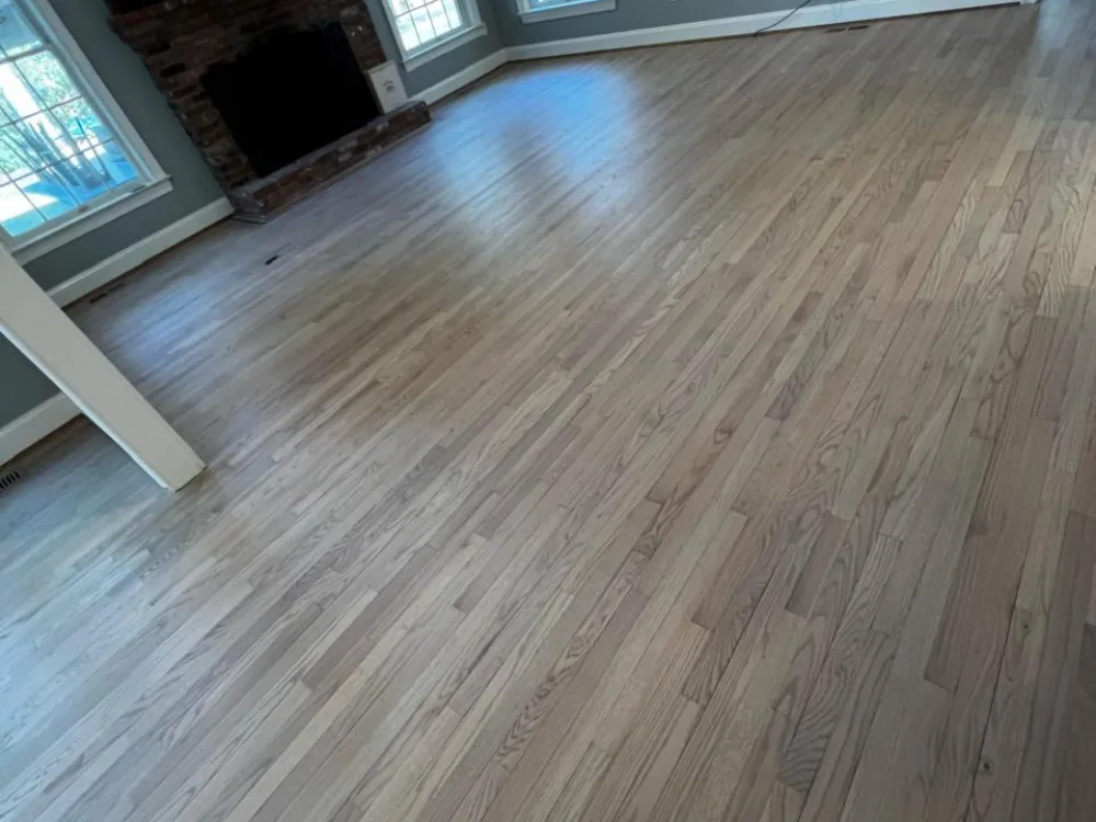 Hardwood floor refinishing in a modern living room with natural light