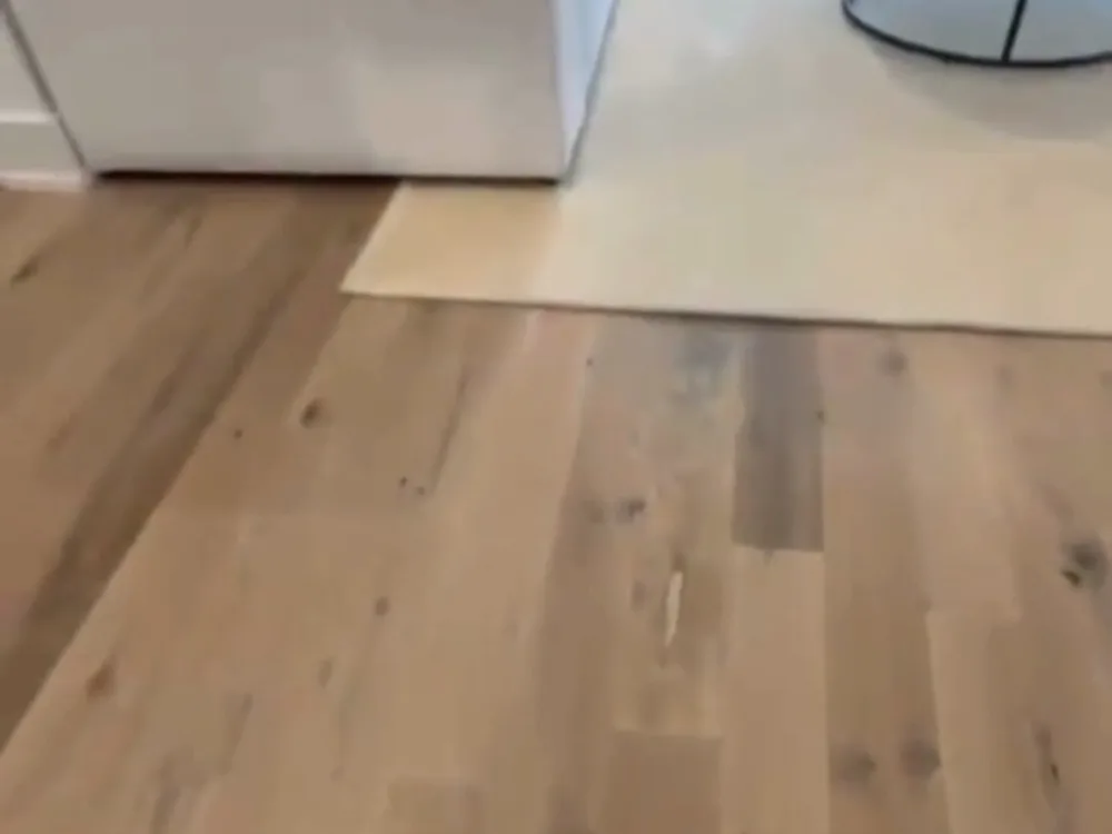 vinyl floor installation in a living area with smooth surface transition