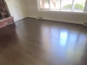 hardwood floor refinishing completed in living room area